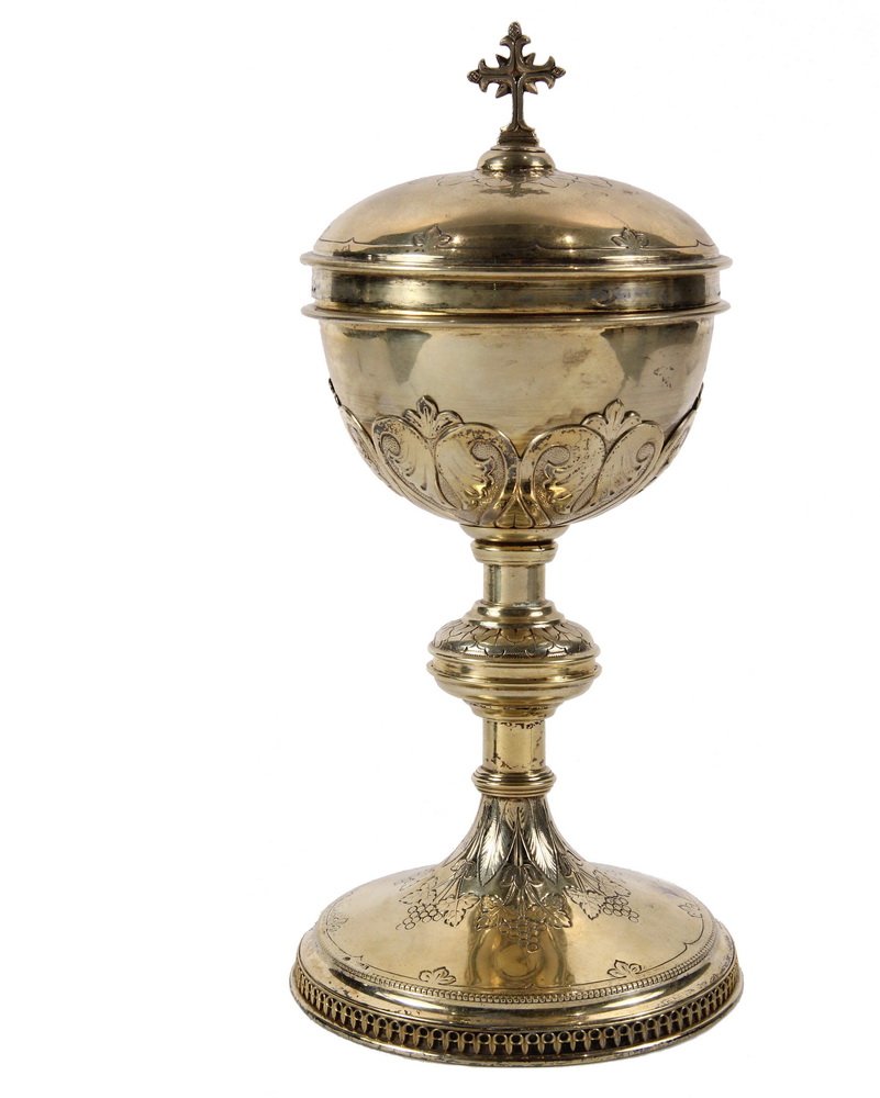 GILT SILVER COVERED CHALICE - Catholic Communion: GILT SILVER COVERED CHALICE - Catholic Communion Chalice with chased decoration of grapevines, cross form knop on the friction fit domed lid, stamped "M.D. Catello" on the inside rim. 11" x 5 1/8" dia