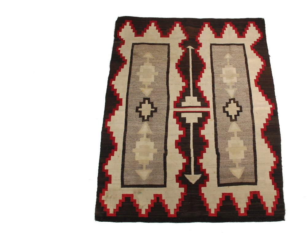 NATIVE AMERICAN RUG - 3'11" x 4'11" - Navajo Rug, circa: NATIVE AMERICAN RUG - 3'11" x 4'11" - Navajo Rug, circa 1900, with vibrant brown, buff, cream, crimson and sand, in a steppe and arrow pattern. A few small ink spots, other stains.