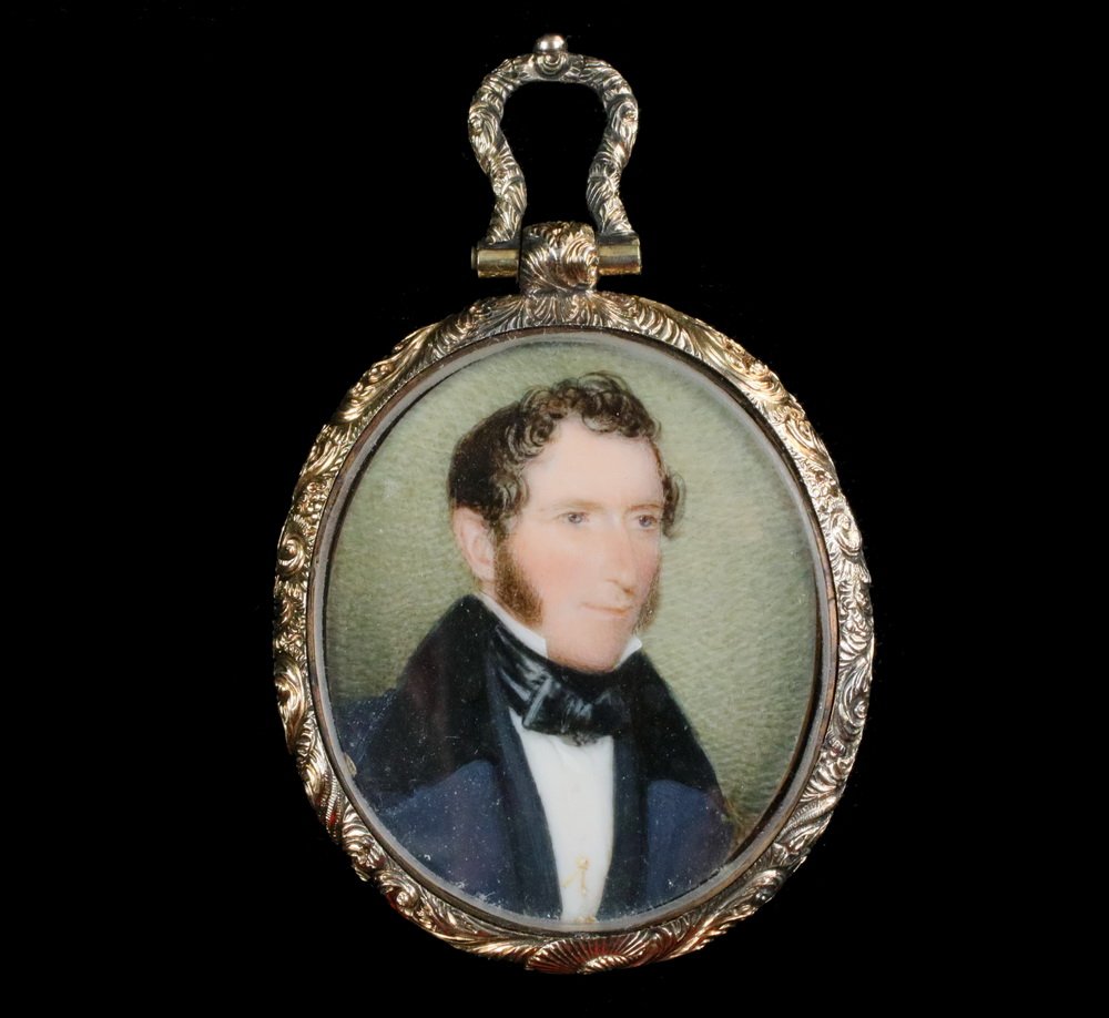 MINIATURE PORTRAIT - Early 19th c. Oval Portrait on: MINIATURE PORTRAIT - Early 19th c. Oval Portrait on Ivory, depicting a young man with black coat and silk tie and gold stickpin, in a fancy engraved gold filled locket form frame with double sided gla
