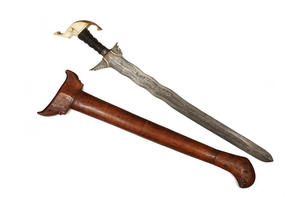 EARLY INDIAN SWORD - Mughal Period Kris, with the: EARLY INDIAN SWORD - Mughal Period Kris, with the original wooden scabbard, having a beautifully shaped ivory pommel derived from an elephant head, the grip wound in tarred cord, with a silver wire ba