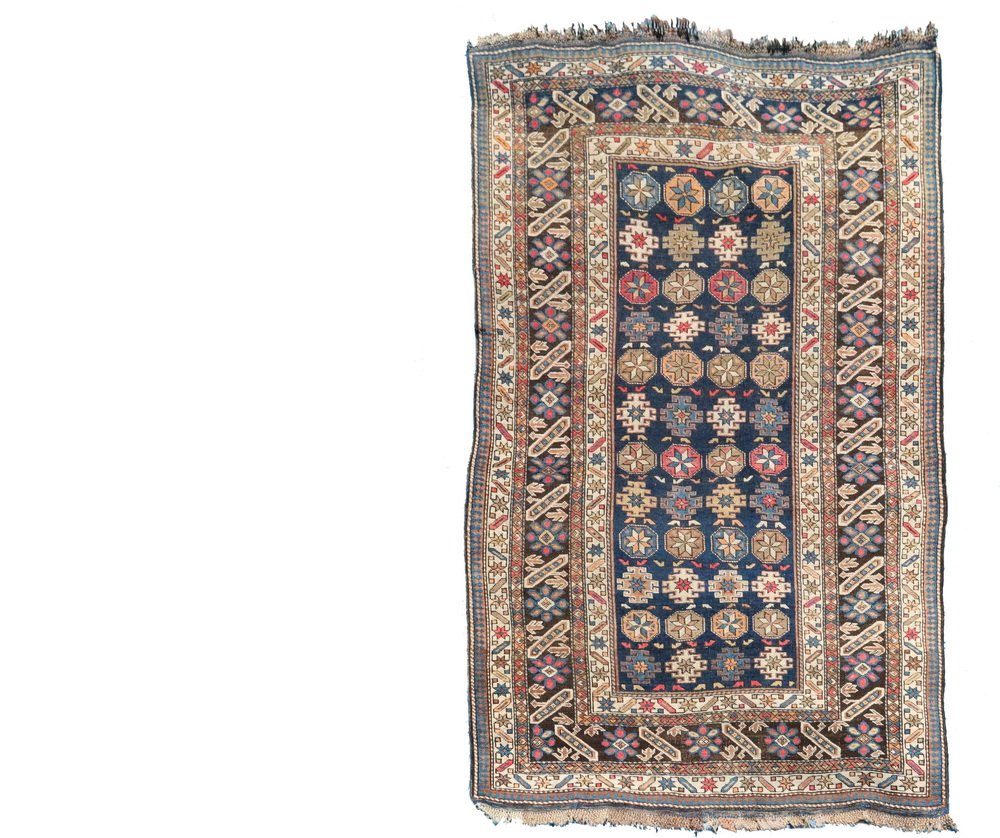 CHI-CHI RUG - 3'8" X 5'9" - Northeast Caucasus, late: CHI-CHI RUG - 3'8" X 5'9" - Northeast Caucasus, late 19th c., alternating rows of stars, octagons and polygons in gold, persian blue, tan and rust, on a midnight blue field, rosette and diagonal bar,