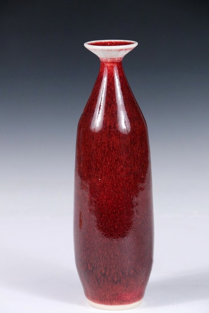 THOMAS BEZANSON (VT, 1929-2007) - Bottle Form Art: THOMAS BEZANSON (VT, 1929-2007) - Bottle Form Art Pottery Vase with Red Copper Glaze and Flared Rim, incised on base "Benedictine Monks, Weston, Vermont" and in marker "URBON", 8 3/8" tall, 2 1/2" dia