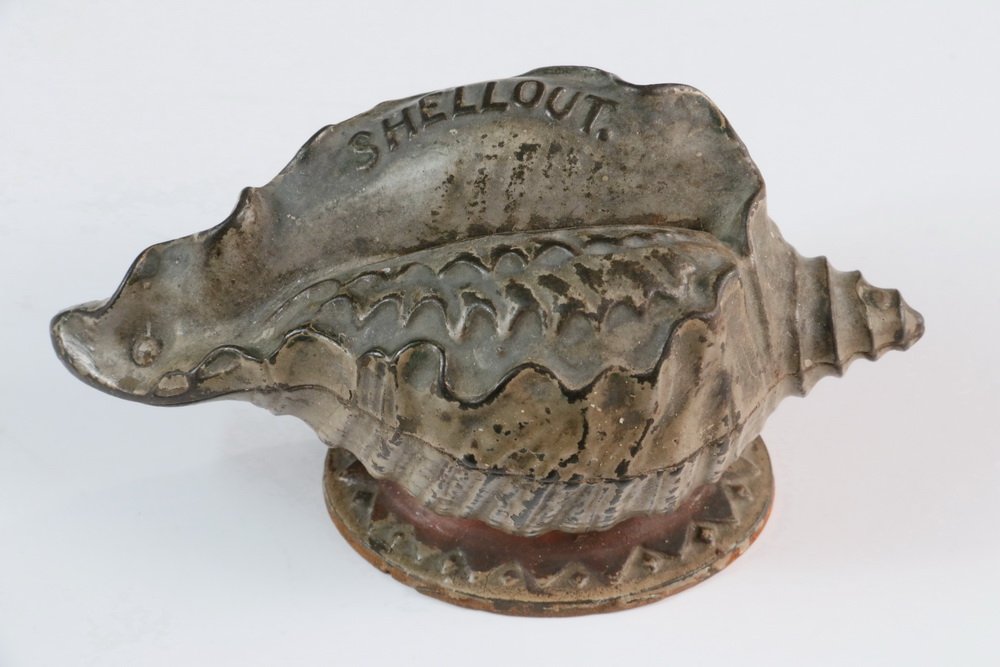 STILL BANK - Cast Iron 'Shellout' Still Bank by J & E: STILL BANK - Cast Iron 'Shellout' Still Bank by J & E Stevens Co., Cromwell, CT, c. 1882, in the form of a seashell, coin trap is impressed 'Patd. Feb 2, 1875', original surface, 2 1/2" high, 5" x 2 1
