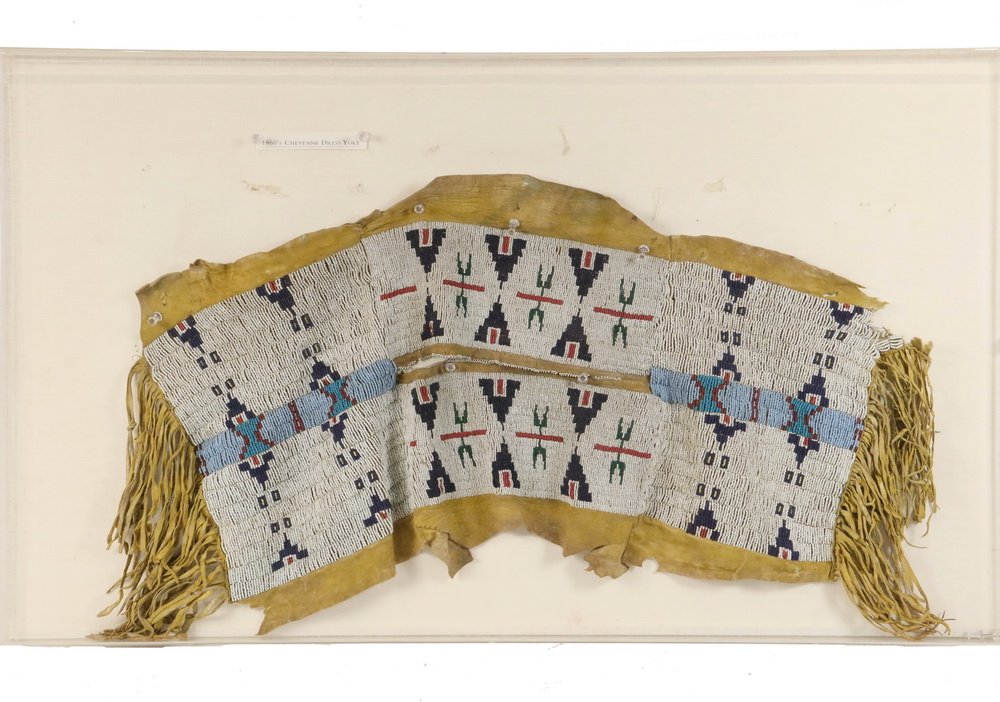 NATIVE AMERICAN BEADWORK - Southern Cheyenne Indian: NATIVE AMERICAN BEADWORK - Southern Cheyenne Indian Girl's Beaded Buckskin Dress Yoke, circa 1860's, Oklahoma/Colorado, in plexiglas showcase, 20" x 33 1/2" x 2", good condition. The Isaacs Gallery Lt