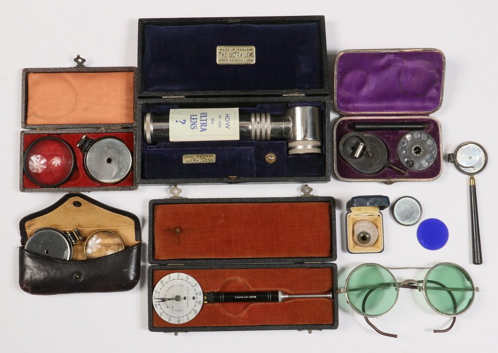 (6) CASED OPTHALMIC INSTRUMENTS, (1) UNCASED &: (6) CASED OPTHALMIC INSTRUMENTS, (1) UNCASED & SUNGLASSES - All 1880-1930, including: "The Ultra Lens" Illuminator, Made in England; PLUS Leather Pocket Kit with Opthalmoscope, by Giroux of Paris; PLU