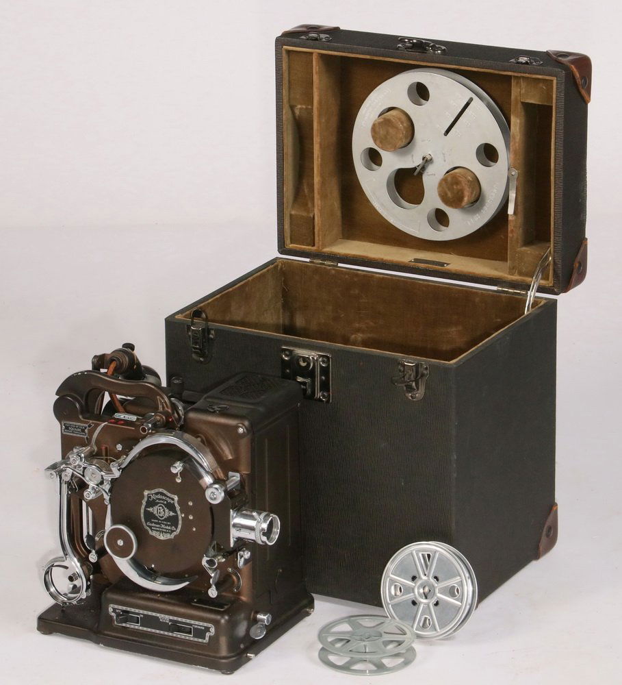 ANTIQUE FILM PROJECTOR - 'Kodascope Model B', by the: ANTIQUE FILM PROJECTOR - 'Kodascope Model B', by the Eastman Kodak Company, Rochester, NY. 16mm. Silent. Circa 1925. In the original case with take up reel, second 'throw' lens, oil, etc. Chromed part