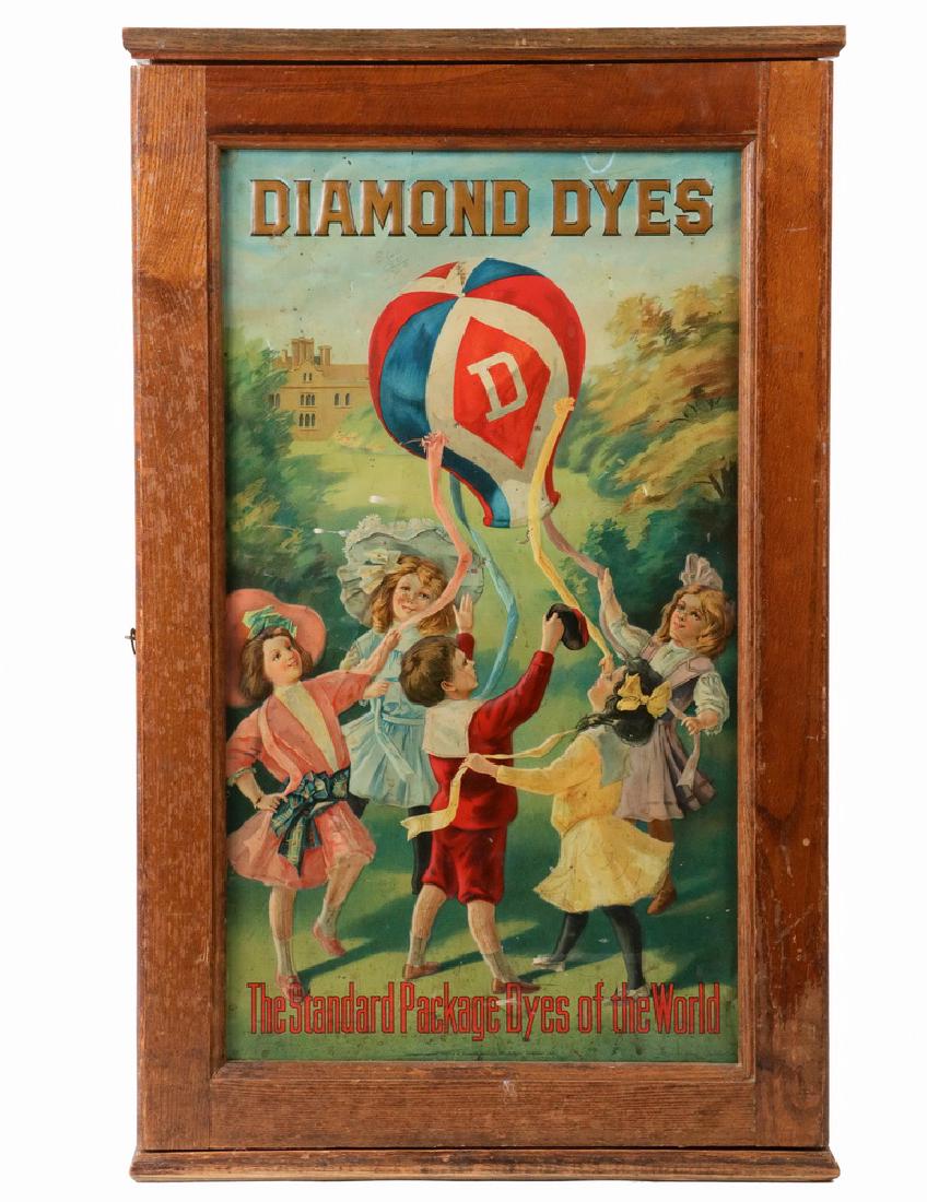 DIAMOND DYE CABINET: Drygood Advertisment Cabinet in oak with tin chromolitho embossed pictorial panel in the door, depicting children with a hot air balloon, original tin litho advertising text panel on back door, the in