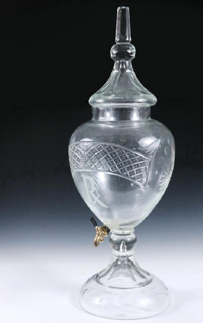 APOTHECARY DISPENSER: English 19th c. Large Cut Crystal Liquid Dispenser in footed urn shape, having bronze spigot, etched 'RX' symbol, arched lattice of brilliant cutwork, tapered lid with truncated obelisk peak, 30 1/2" 