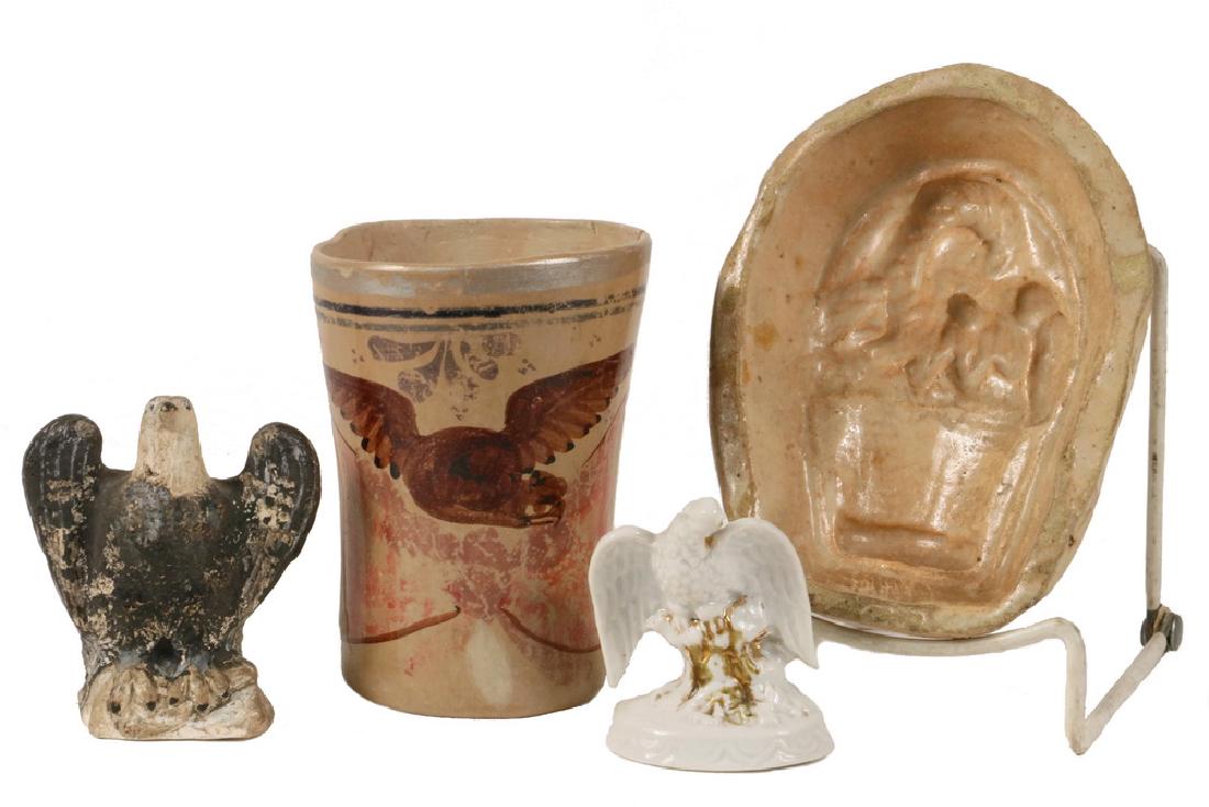 (4 PCS) FEDERAL PERIOD EAGLE THEMED POTTERY: Including: Tan Clay Beaker painted with Eagle flanked by French Flags, 4 1/2" tall, chipped rim and hairline; Homemade Small Food Mold of Eagle atop Basket, 5 1/4" x 4"; PLUS Small Bisque Eagle with g