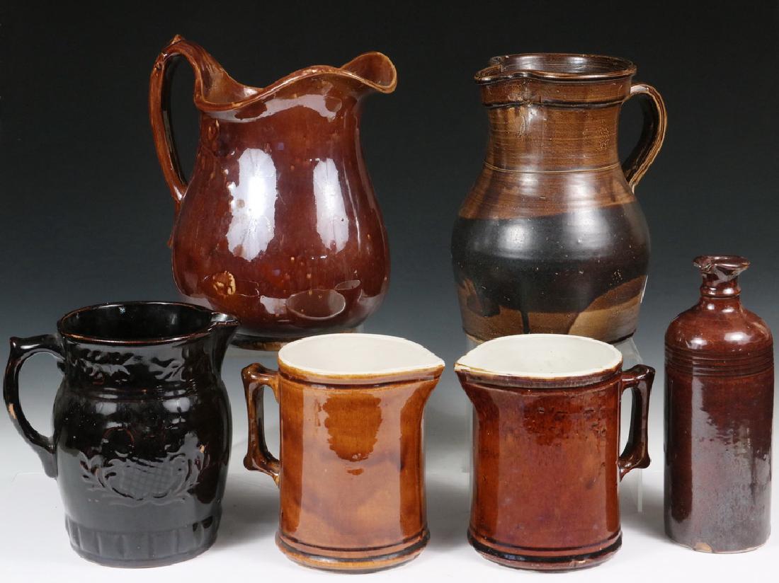 STONEWARE: Collection of (6) Pieces of Brown Glazed Stoneware Pottery, including: Pitcher with embossed floral and swag decoration, glossy glaze, 8" high, 8" wide incl handle, good condition; Bottle with pour sp