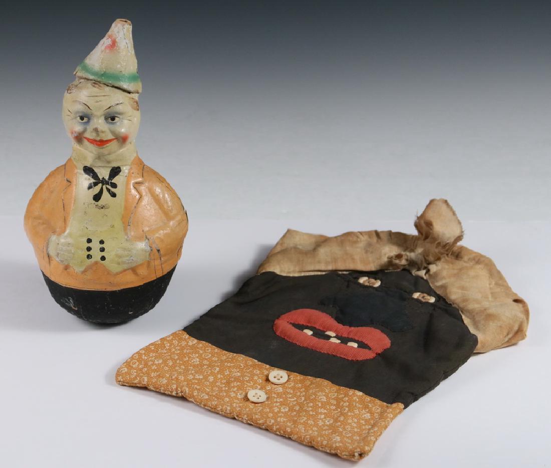 (2 PCS) AMERICAN FOLK ART: Home Made Fabric "Mammy" Head Pot Holder, 12 1/2" x 9", toned and stained; PLUS Papier Mache Roly Poly Billiken Clown, hand painted, 10" tall. Tip of hat gone.
