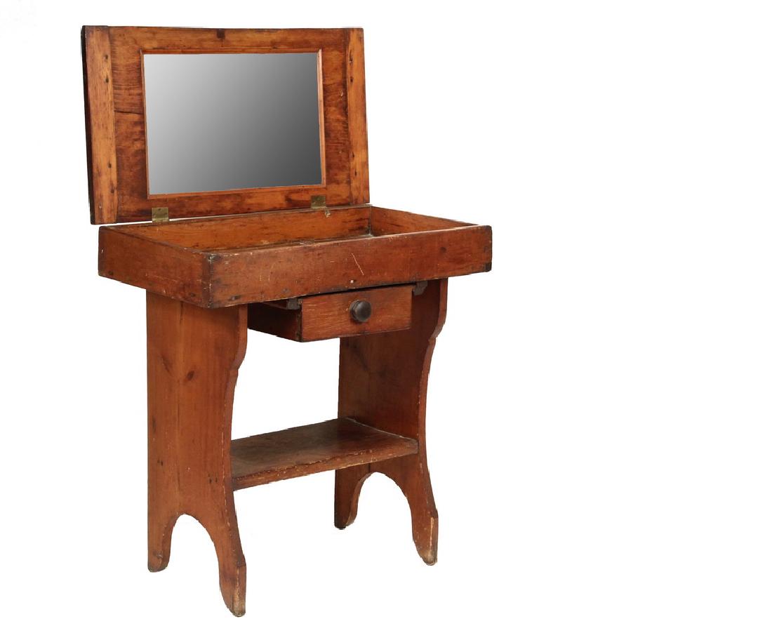 DRY SINK AS VANITY: 19th c. Country Pine Dry Sink converted to a vanity by the addition of a mirror to the underside of the hinged lid, having a single underslung drawer with mushroom knob, trestle base with lower shelf.