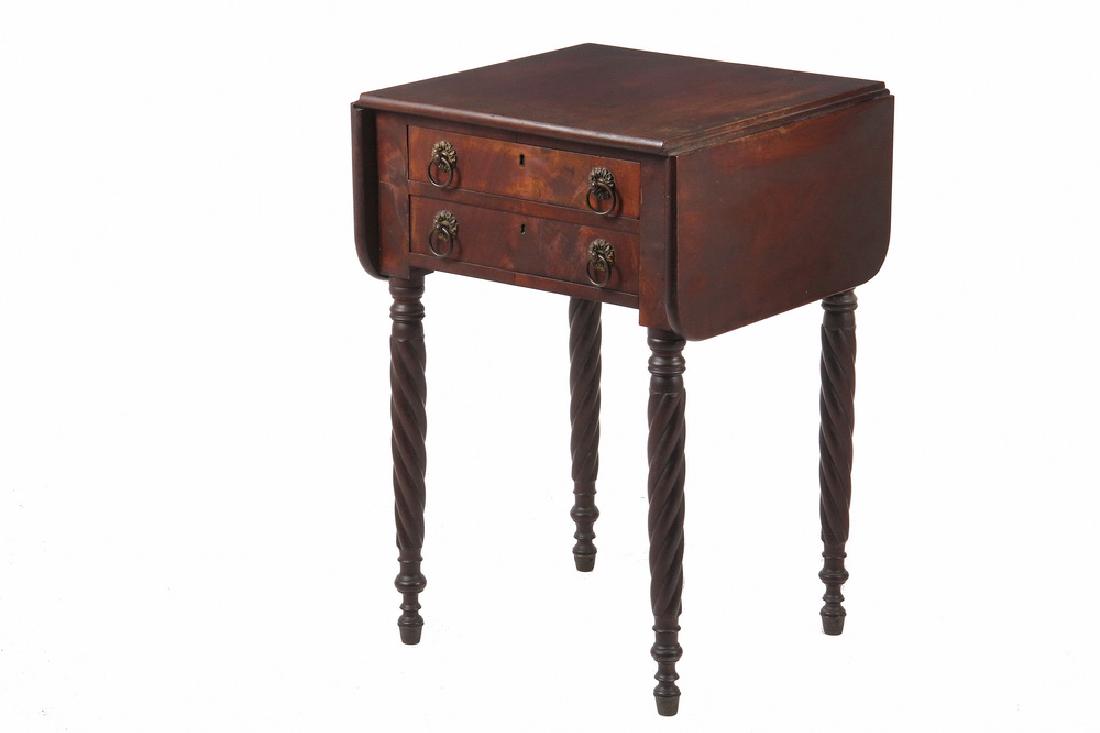 FEDERAL PERIOD WORK TABLE: Two Drawer Sheraton Mahogany Stand with drop leaves, flame veneer drawer fascias with brass drop ring pulls, top drawer is partitioned for ink bottles and pens, set on ring turned and reverse bow-twis