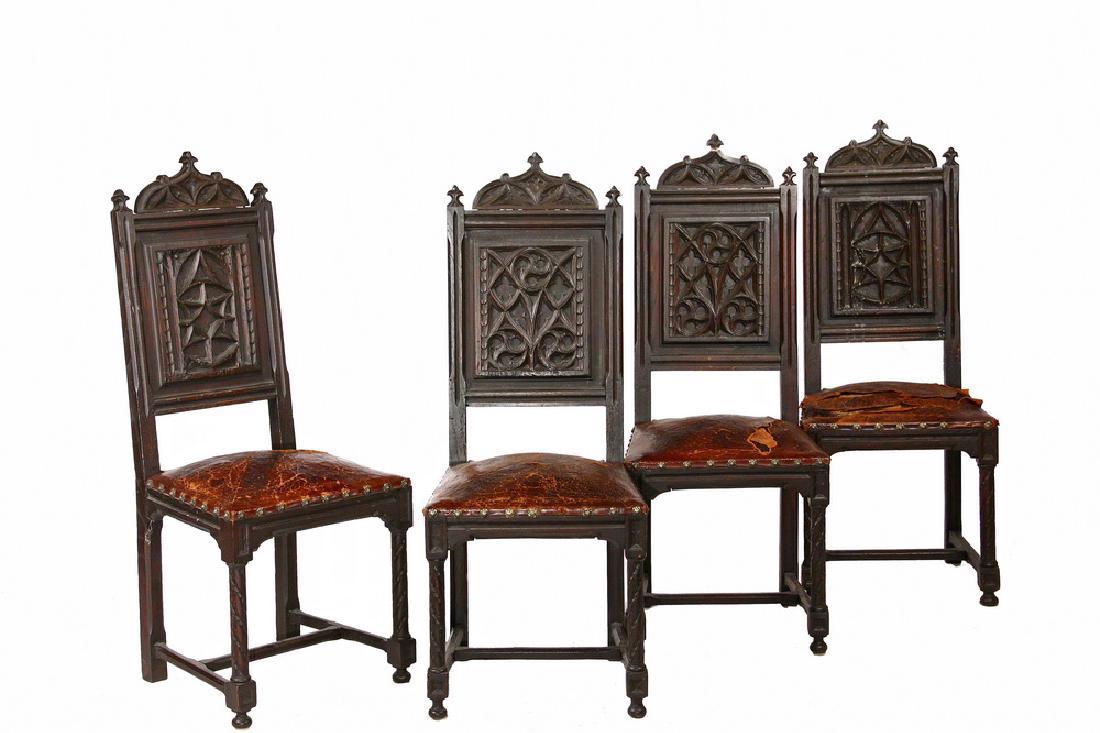 (SET OF 4) ENGLISH DINING CHAIRS: 19th c. Gothic Revival Carved Oak in dark walnut finish, having remnant of embossed leather upholstery, fleur-de-lis finials and brass nail heads, relief tracery in back panel, chip carved barley twis