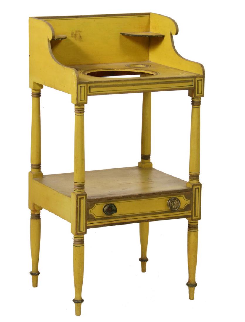 SHERATON WASHSTAND: Early 19th c. Maine Made Yellow Painted Softwood Washstand, with gold and black pinstriping, having a tall gallery with corner shelves for candles, scrolled sides, the top holed for the washbowl, two 
