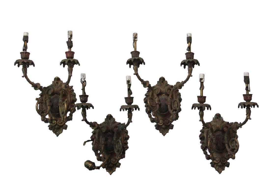 (4) MATCHING SCONCES: Louis XV French Style Two Arm Sconces, 1920s vintage, in gilt and polychromed iron and brass, wired for electric, roughly 16" x 9" x 7 3/4". Good condition, drilled for mounting, missing candle covers