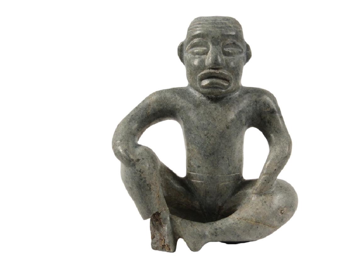 PRE-COLUMBIAN STYLE CARVING: Olmec Greenstone Carving of a Seated Figure, Gulf Coast of Mexico, roughly 8 1/2" x 6 1/2" x 3". Repaired legs, portion of one foot gone.
