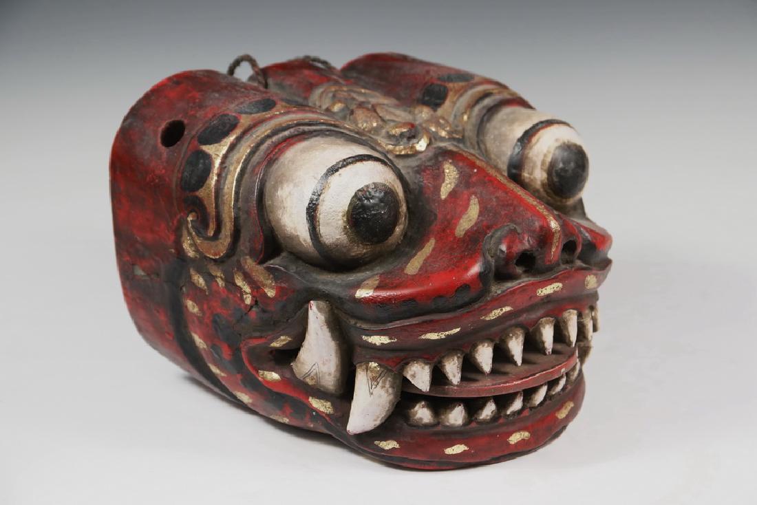THAI PARADE MASK: Carved, Painted and Gilt Softwood Dragon Head Mask, 20th c., with moveable tongue. 9 1/2" x 9 1/2" x 6 1/2". Good condition.