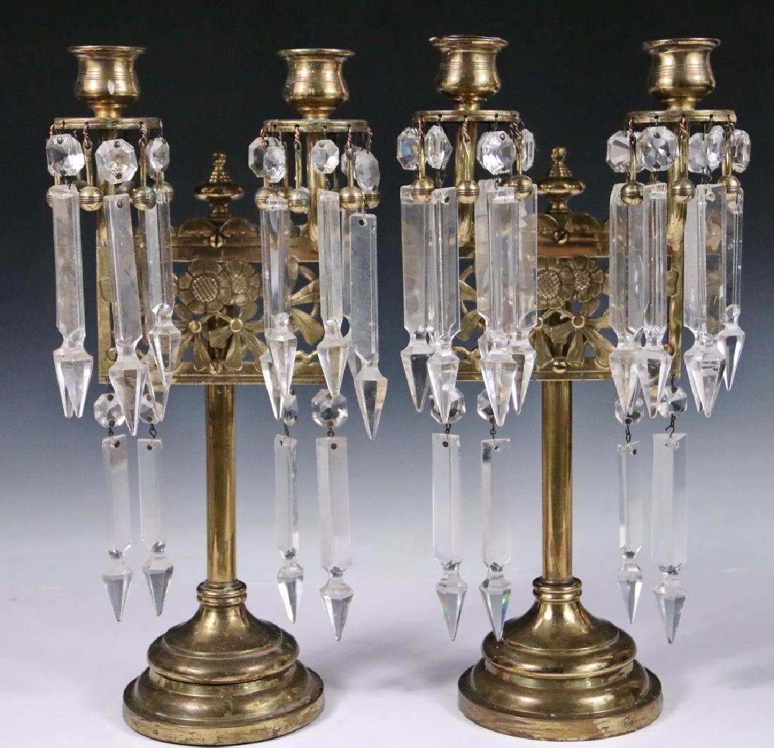 PAIR OF MANTEL LUSTRES: Edwardian Brass and Crystal Two-Arm Candelabrum with reticulated floral decorative panel, brass drop beads alternating with the crystals, 13 3/4" tall. Good condition.