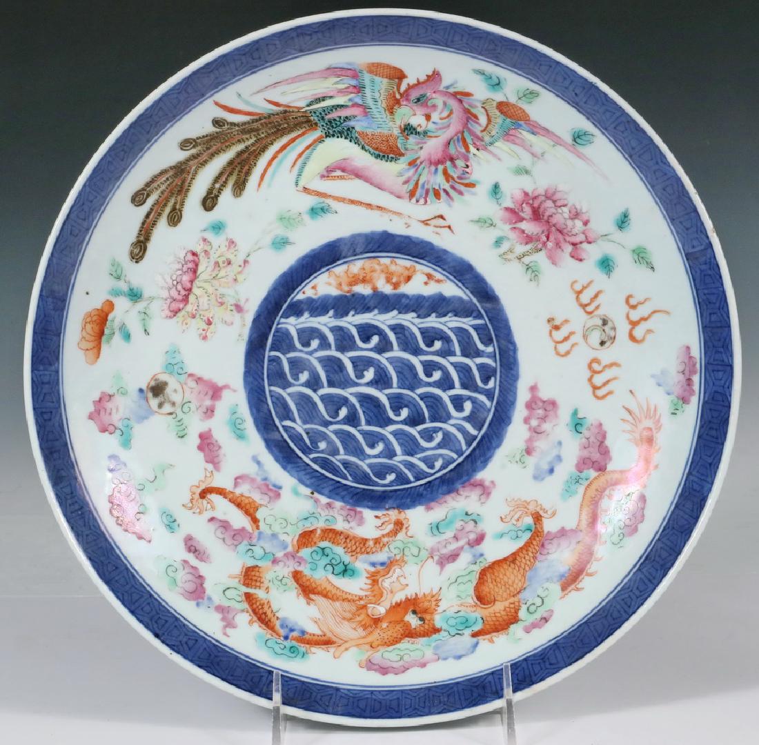 CHINESE EXPORT CHARGER: Qing Dynasty Charger, with red Yongzheng mark, circa 1730, having a cobalt banded edge and inner cartouche containing a bat above sea waves, the white ring featuring a dragon opposing a phoenix bird, 