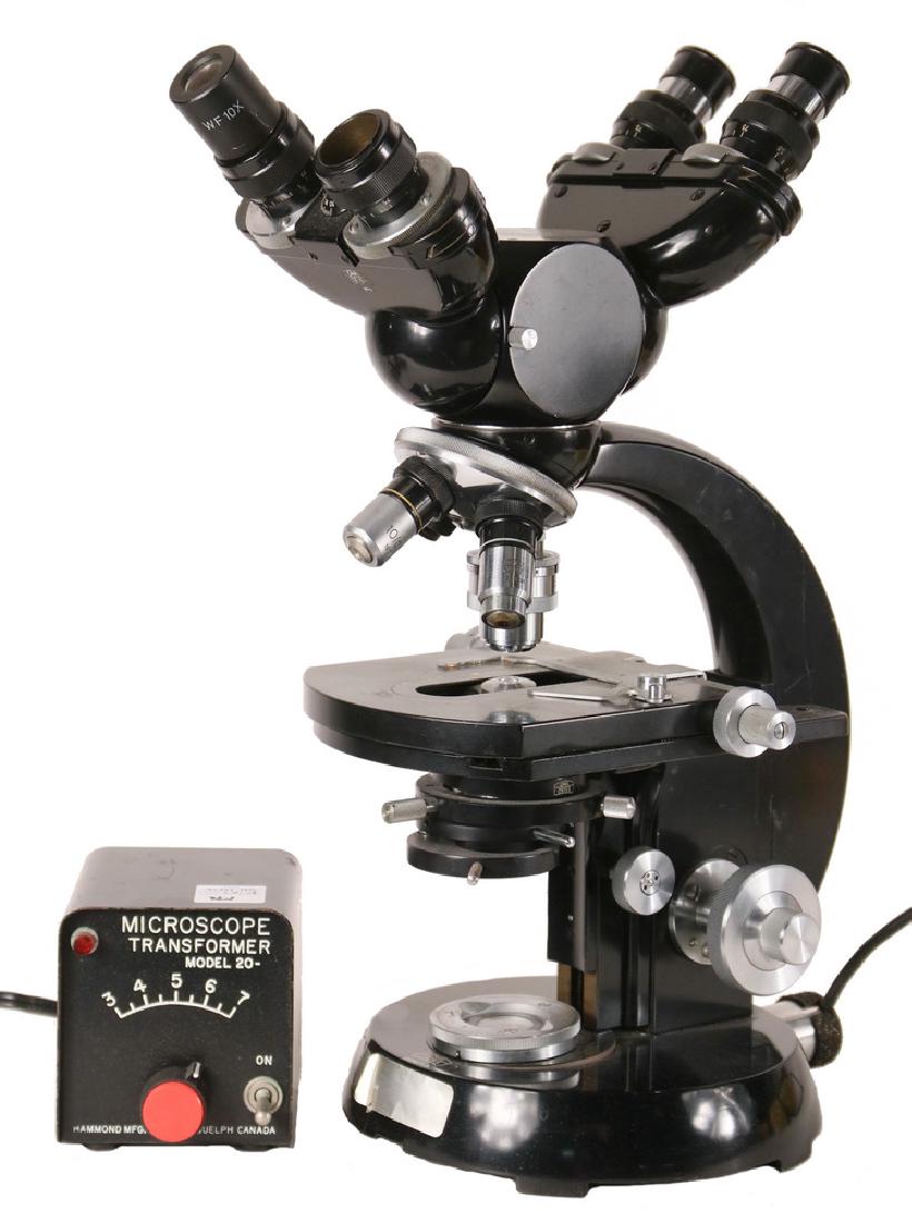 VINTAGE MICROSCOPE: Carl Zeiss Compound Polarizing Petrographic Microscope, s/n 2056717, with table having s/n 2107371, frame marked Hughes-Owen, with four lens objective, double sets of eyepieces set on rotation, iris c