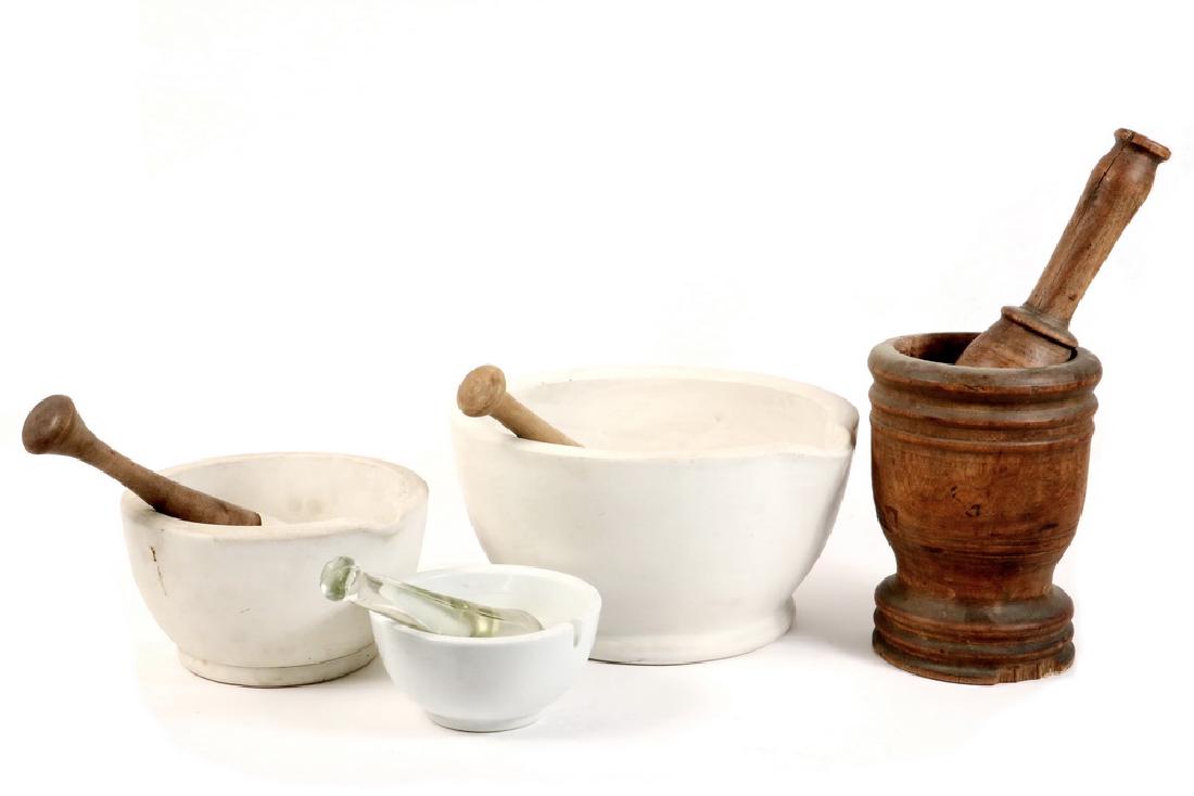 (3) GRADUATED PORCELAIN MORTAR & PESTLE AND (1) IN WOOD: Late 19th to early 20th c. Porcelain Mortar and Pestle, 6 1/4" x 11 3/4 diam. with wood and porcelain pestle; 4 3/4" x 8 1/4" diam. with same type of pestle; 3" x 6" diam. with (2) glass pestles; good