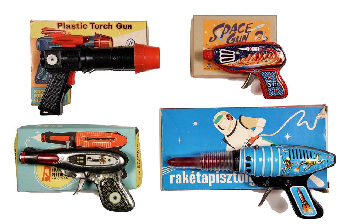 (4) TOY SPACE GUNS IN BOXES: "Raketapisztoly", Lemezaru Gyar, Hungary; "Sparking Friction Pistol", MF116, tin, Made in China; "Plastic Torch Gun", No 106, plastic, W tm, Empire Made; "Space Gun", Japan.