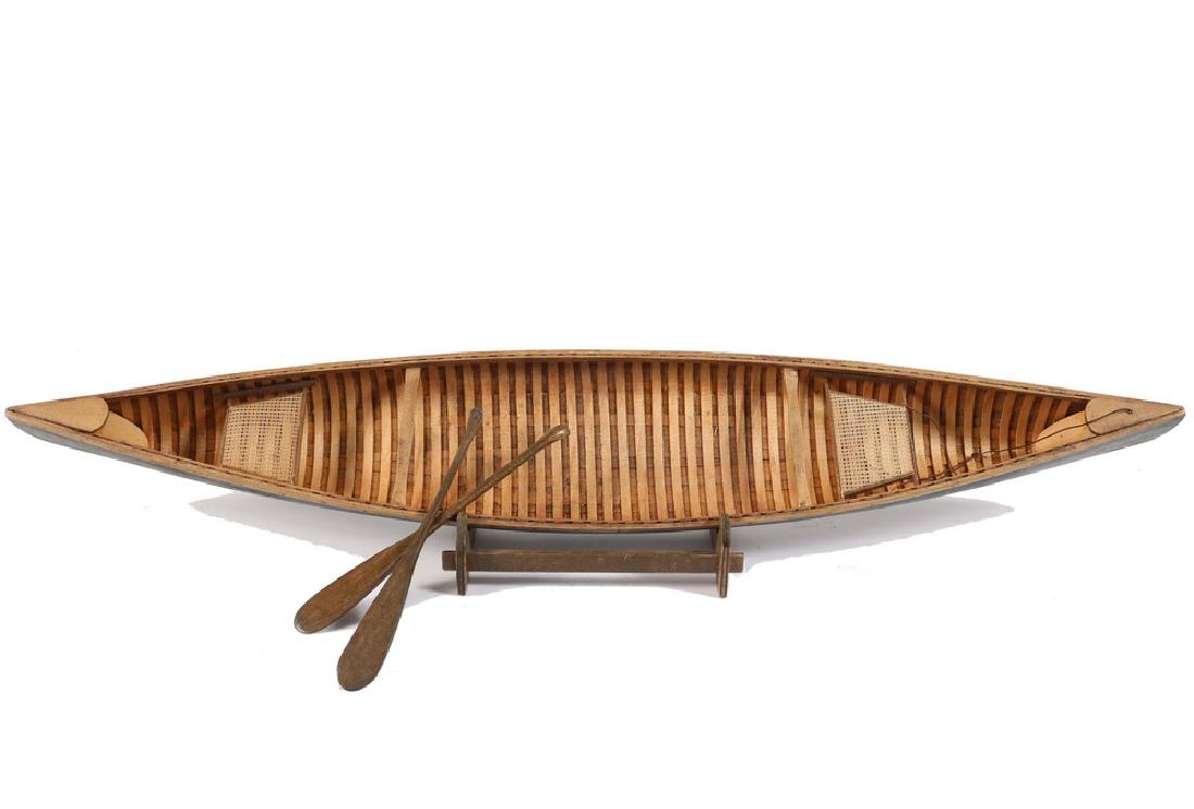 CANOE MODEL: Planked Cedar Rib Maine Canvas Canoe Model from kit, with paddles, circa 1930. On stand. 27" long. Fine condition.