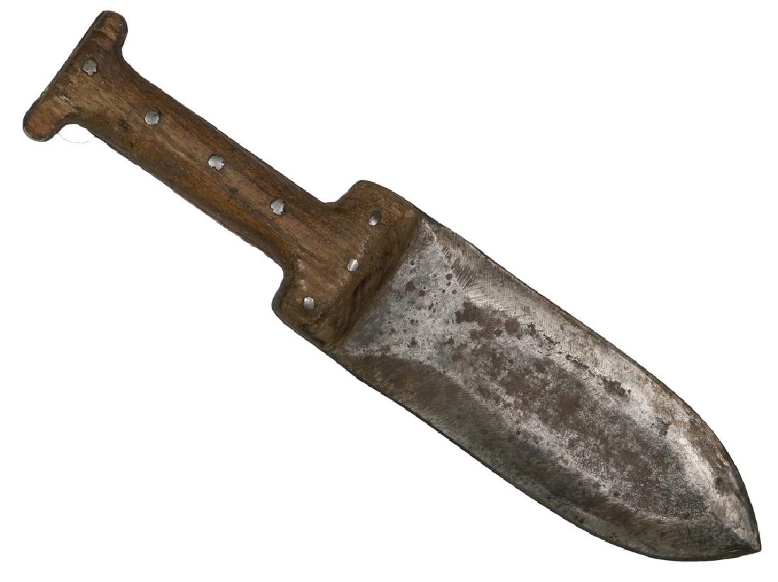 NATIVE AMERICAN KNIFE: Northern Plains Fighting Dagger, with a broad double edged trade blade stamped with an S inside a C and with the number 568, roughly sharpened, and having riveted hand carved oak handles. 11" long ove