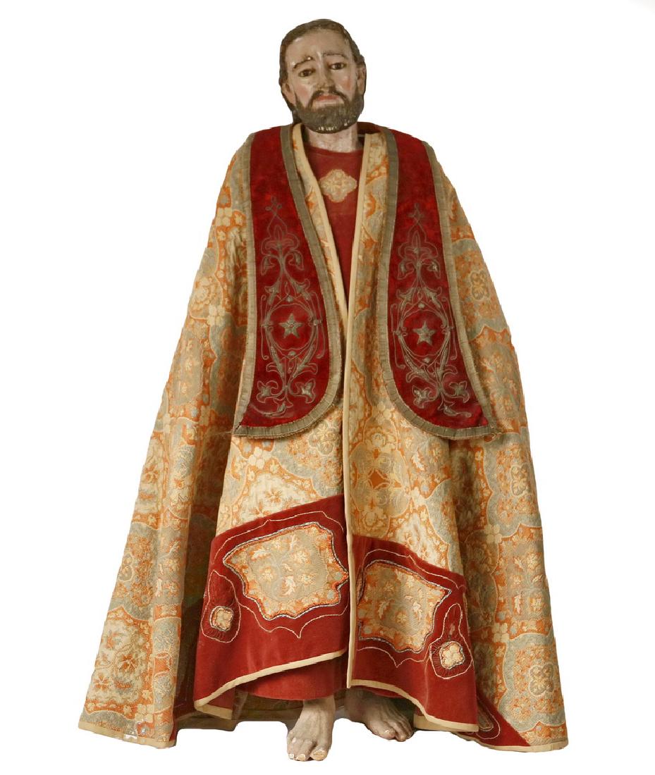 ECCLESIASTICAL FIGURE: Catholic Standing Figure of Christ, circa 1900, in polychromed gesso over wood, having glass eyes, jointed arms, rigid legs (bare feet), the clothing a mixture of old and new vestments, a wine velour 