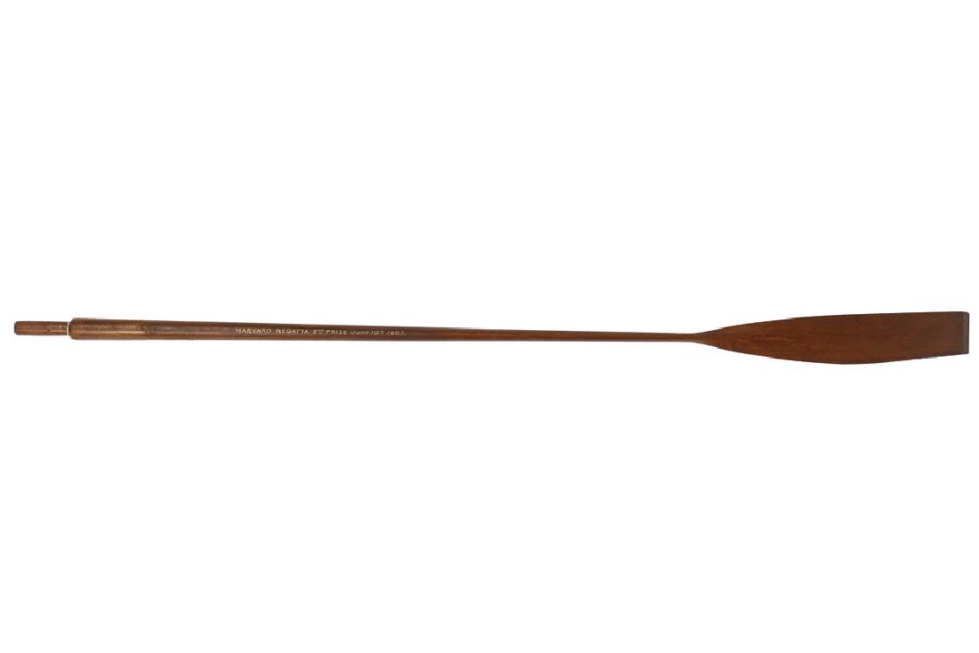 19TH C. HARVARD PRIZE OAR: Slender Mahogany Sculling Oar with painted gold and black inscription "Harvard Regatta, 2nd Prize, June 10th, 1867." A beautifully refined form. 60" long. Missing a portion of the blade. The Regatta,