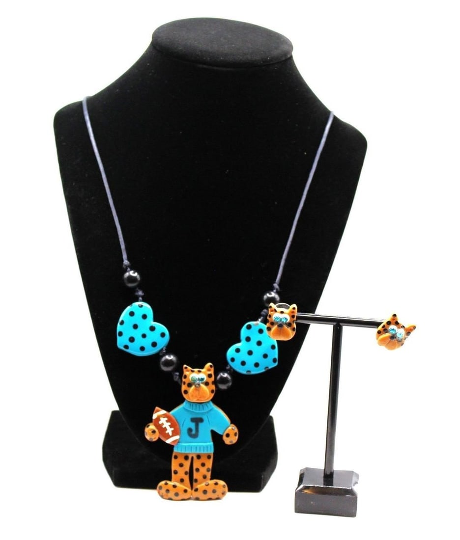 HANDMADE JAGUAR FOOTBALL TEAM JEWELRY SET: Very cute vintage handmade Jaguar Football Team clay Jewelry set of necklace and pierced stud earrings. Good overallDimensions: Necklace 22"L Stud Earrings 0.5"X 0.5"Weight: 27.7 grams