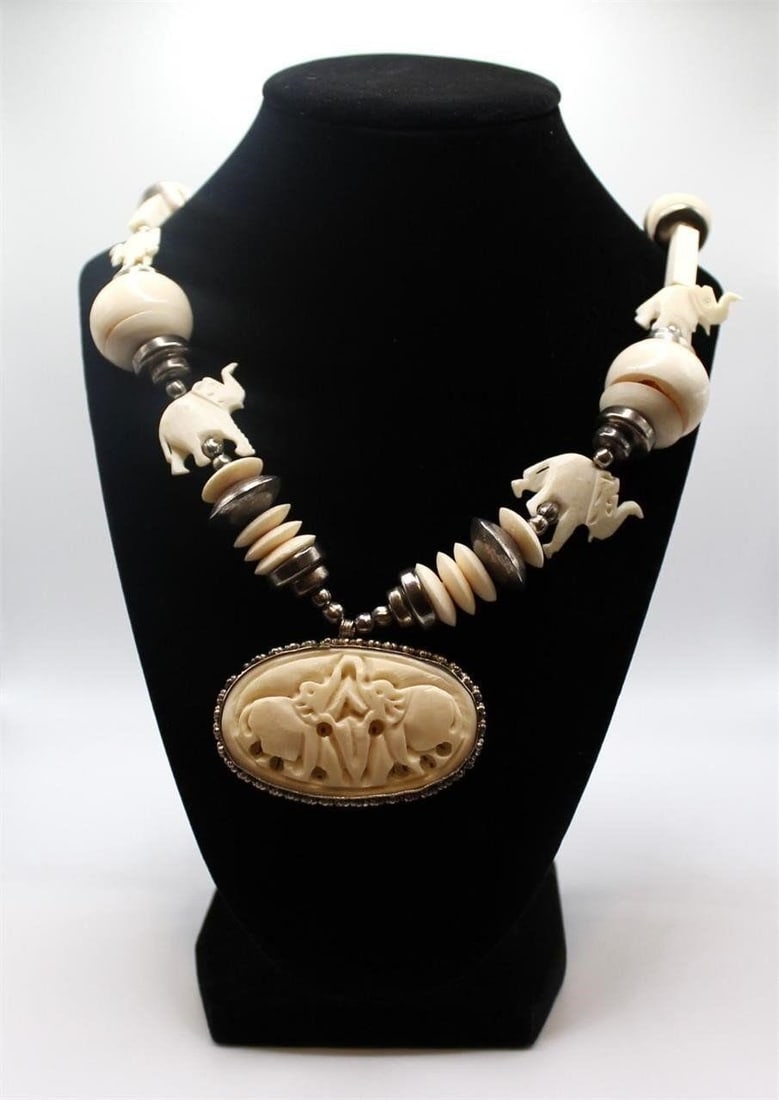 VINTAGE DETAILED CARVED BONE ELEPHANT NECKLACE: Beautiful Vintage detailed carved bone elephant medallion necklaceDesigner/Brand: UnknownMetal Purity: Silver tone settingMetal: Silver tone settingStone: carved boneWeight: 100.5gramsDimensions: 28"L