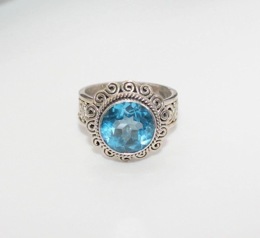 SUARTI BALI 6.5 CARAT BLUE TOPAZ STERLING RING 8: Vintage Suarti Bali BA 6.5 Carat Blue Topaz Sterling RingDesigner/Brand: Suarti Bali BAMetal Purity: 925Metal: Sterling SilverStone: 6 Carat Blue Topaz Weight: 10.6gramsDimensions: Size 8