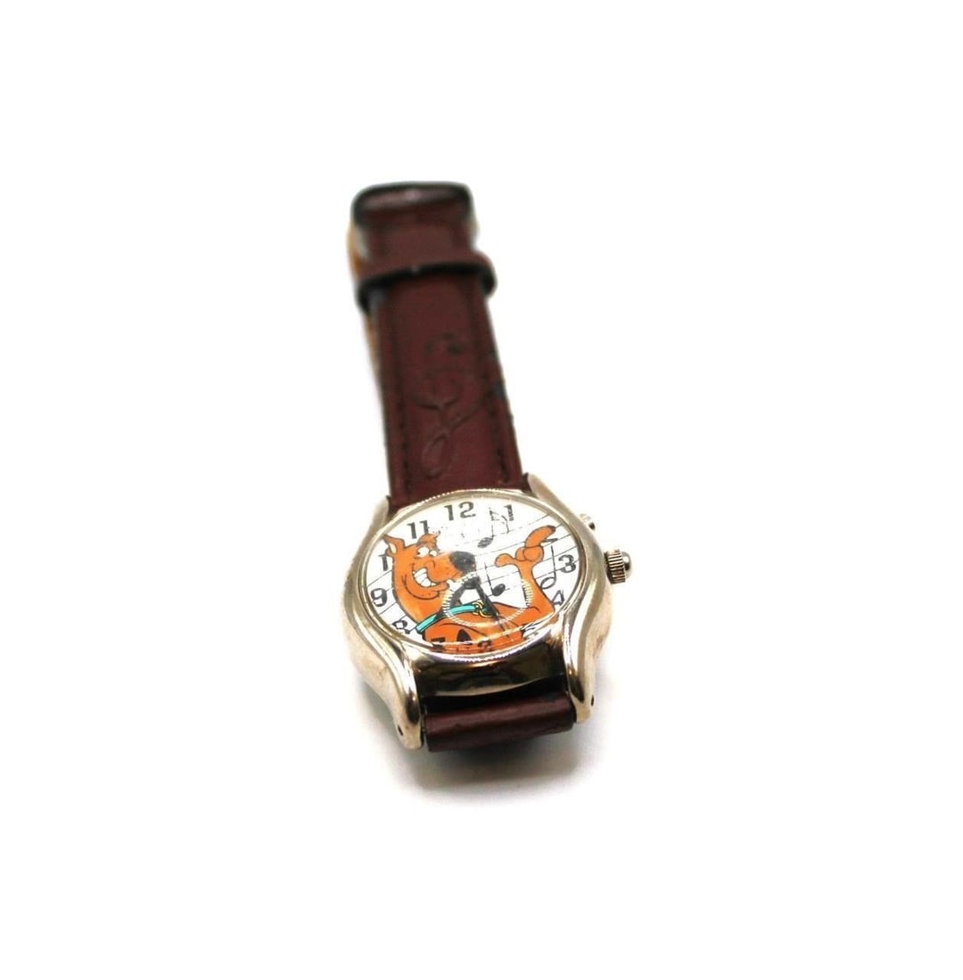 VINTAGE SCOOBY DOO GLUCK MUSICAL WATCH-UNTESTED: Vintage Scooby Doo Musical watch untested - with signs of wear may need to replace band and new batteryDesigner/Brand: Gluck CorporationMetal Purity: stainless steelMetal: stainless steelStone: noneWe