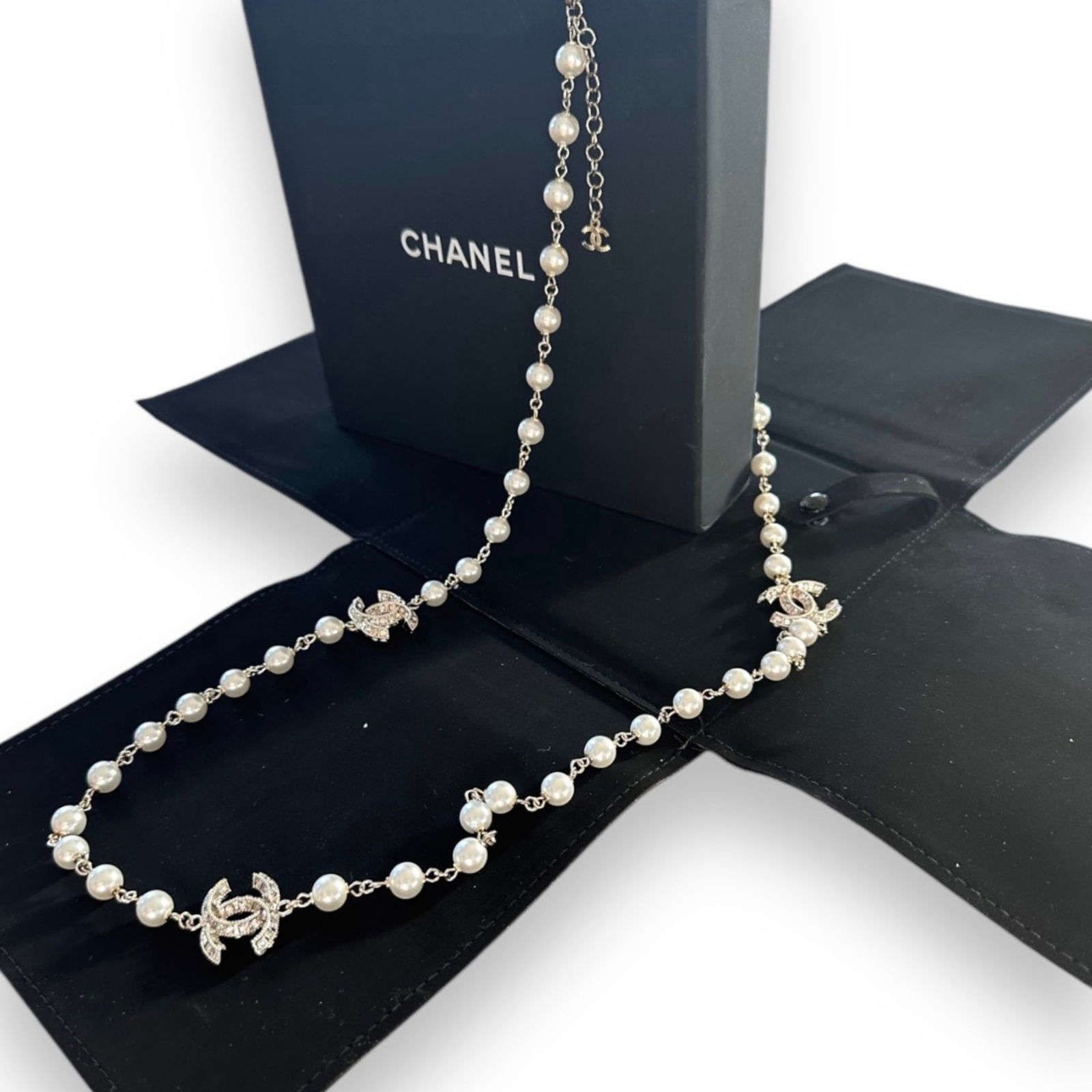 CHANEL 23A Pearl & Crystal CC Necklace: • CHANEL• Silver Tone• Pearl & Crystal CC Accents• Double Layered• Length Adjustable• 39” Long As A Single Loop• Original Box, Dust Bag Included, & Certificate