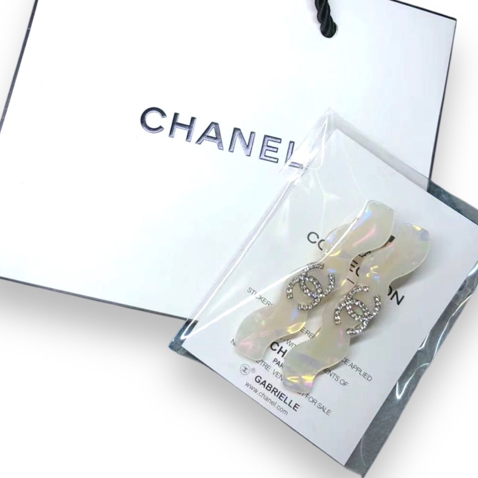 CHANEL 2Pc Set White Opal W/ Rhinestone CC Logo L.A Collection Hair Clips: • CHANEL • Gabrielle • 2Pc Set• White Opal• White Rhinestone CC Logo• Zig Zag Pattern• L.A Collection• Hair Clips/Hair Pin • Unopened/In Original Packaging