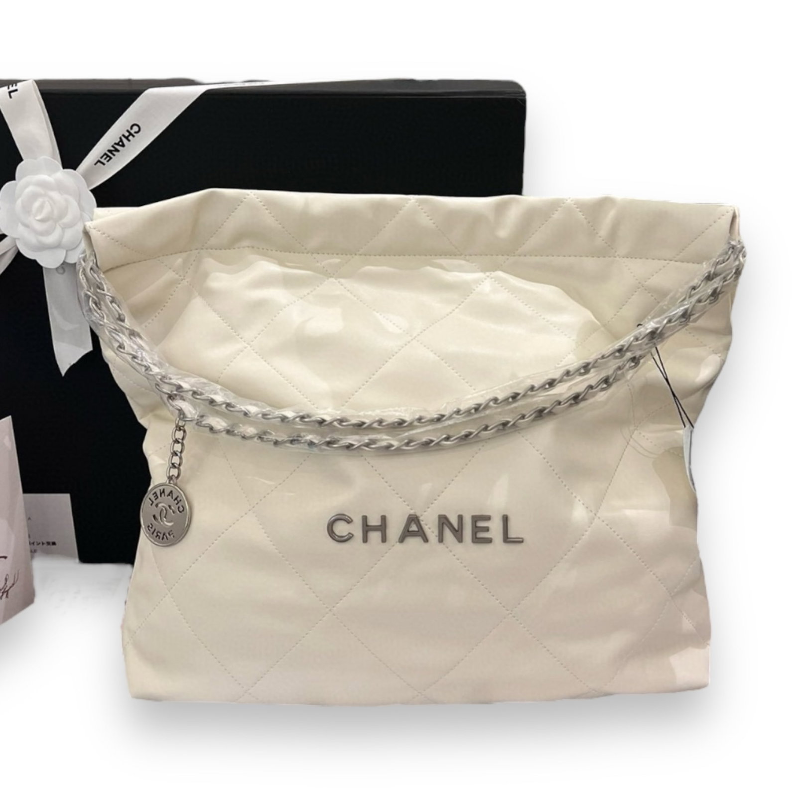 CHANEL Quilted White & Silver 22 Shiny Beaute Bag & Pouch: • CHANEL• 15.3" x 14.1" (in)• White 22 Hobo Bag • Shiny • Matching CHANEL Pouch Included• Silver Tone Hardware• Drawstring Closure• Vegan Leather• Front CH