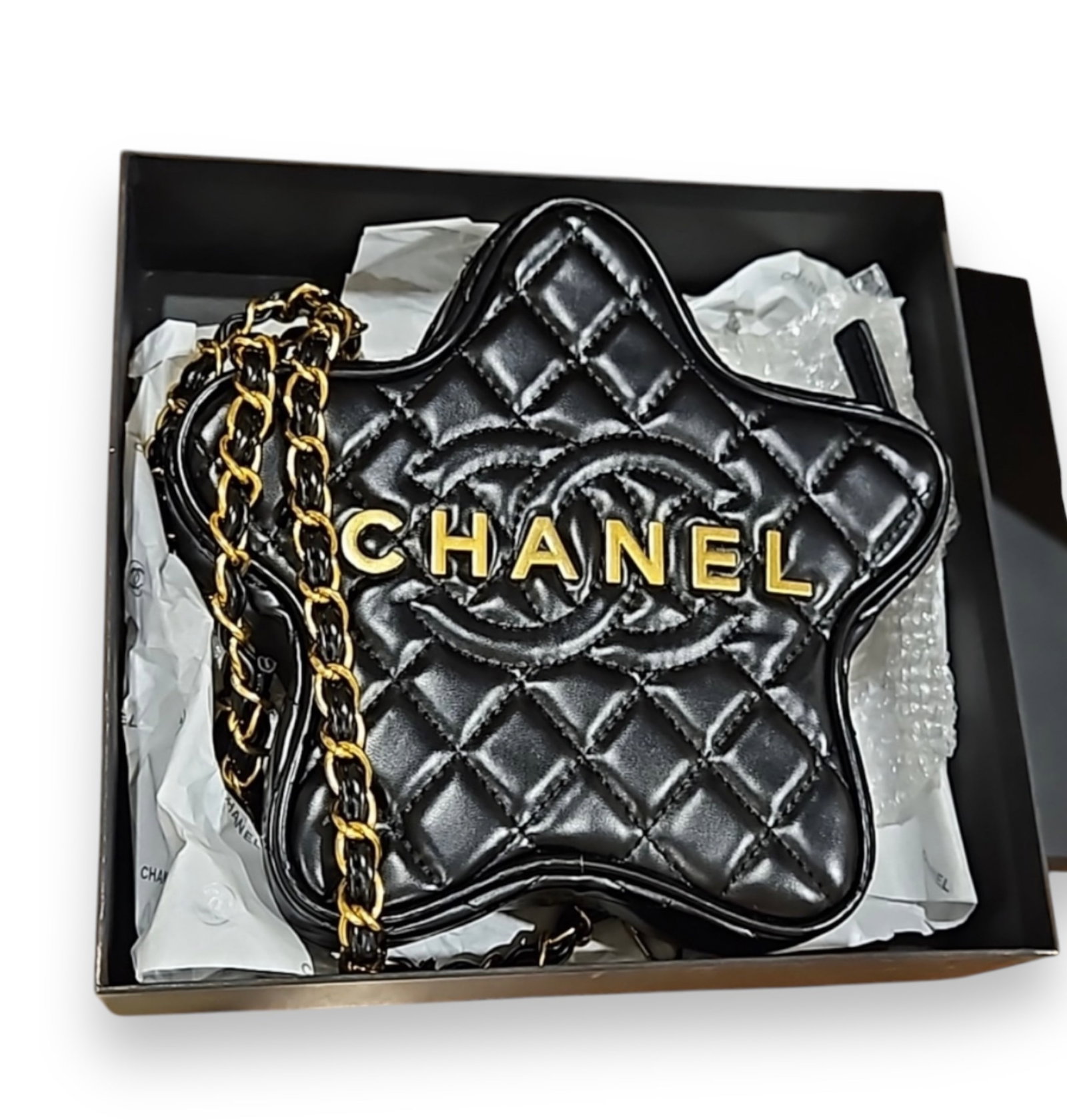 Black/Gold Quilted CHANEL Beaute Star Bag: • Chanel • Quilted Pattern • Black• Gold Tone Hardware• Interwoven Chain Shoulder Strap• Exterior Slip Pocket• Canvas Lining• Dual Interior Pockets• Zip Cl