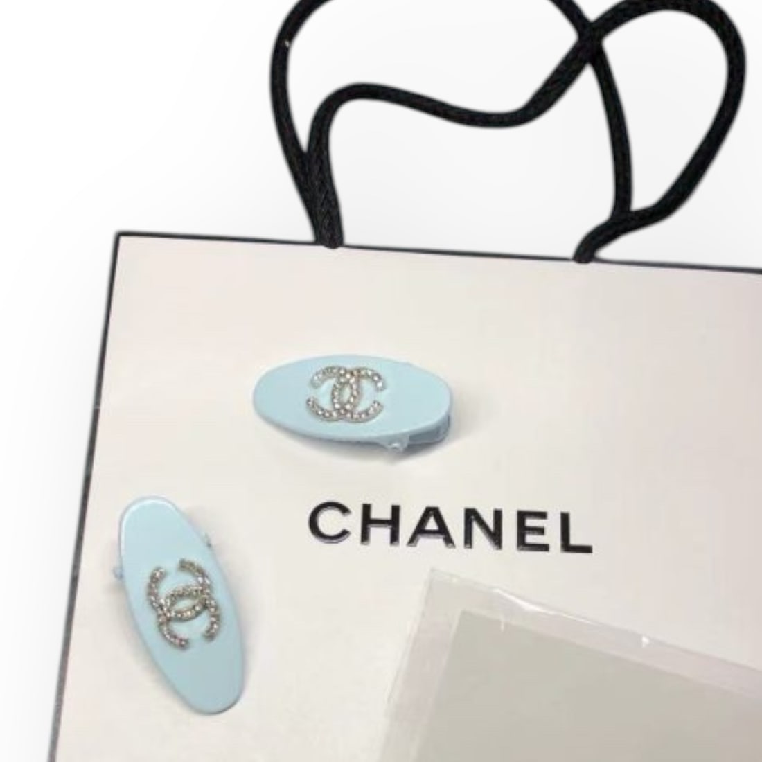 CHANEL 2Pc Baby Blue/White Rhinestone CC Oval L.A Collection Hair Clips: • CHANEL • Gabrielle • 2Pc Set • Hair Clips • Baby Blue • White Rhinestone CC Logo • Silver Tone Hardware • Oval Shaped • L.A Collection • Unopened/In