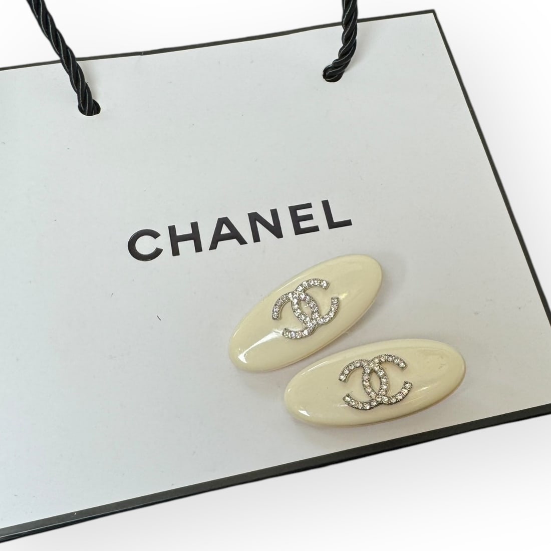 CHANEL 2Pc Cream/White Rhinestone CC Oval L.A Collection Hair Clips: • CHANEL • Gabrielle • 2Pc Set • Hair Clips • Cream • White Rhinestone CC • Silver Tone Hardware • Oval Shaped • L.A Collection • Unopened/In Original