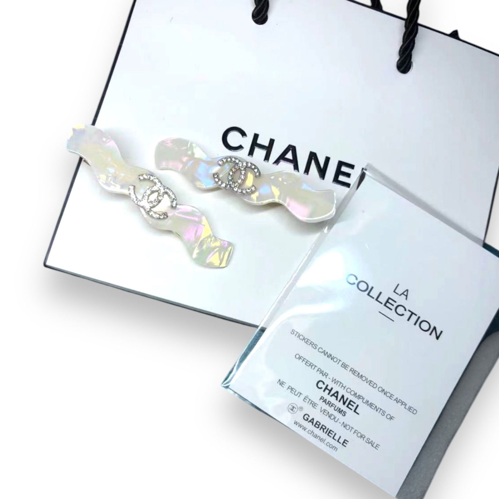 CHANEL 2Pc Set White Opal W/ Rhinestone CC Logo L.A Collection Hair Clips: • CHANEL • Gabrielle • 2Pc Set• White Opal• White Rhinestone CC Logo• Zig Zag Pattern• L.A Collection• Hair Clips/Hair Pin • Unopened/In Original Packaging