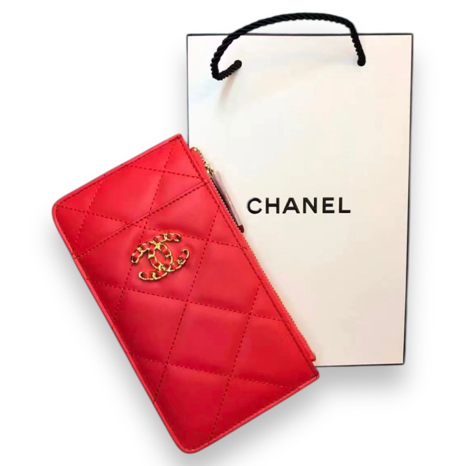 CHANEL Red Long Intertwined Logo Beaute Card Holder & CHANEL Gift Bag: • CHANEL• Red• Quilted Pattern • Gold Tone Hardware• Cell Phone/Card Holder• Intertwined CC Logo• 7.6” x 4.3” (in)• In Original Packaging• Card