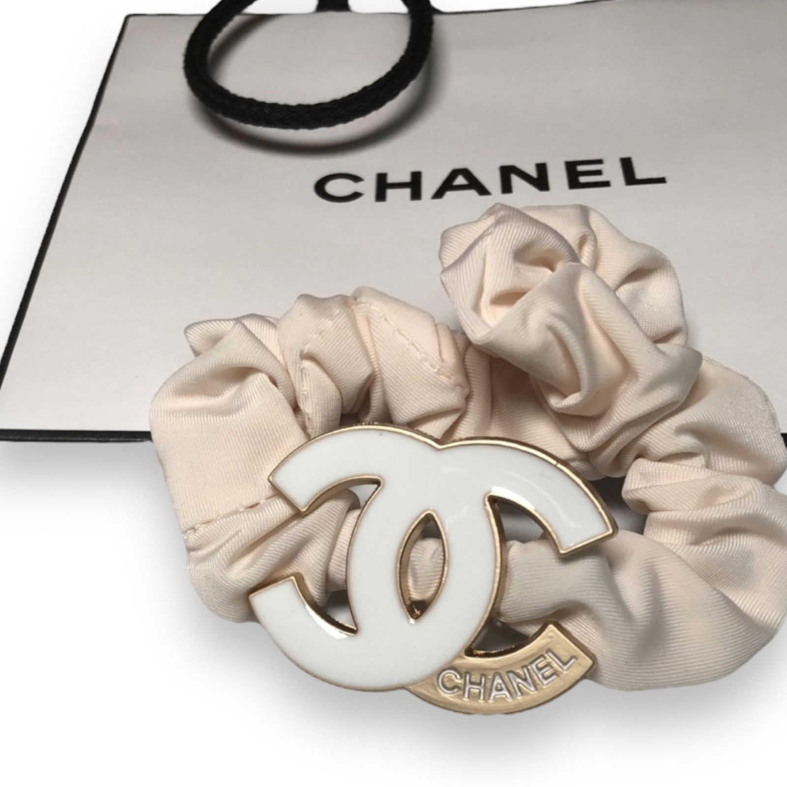 CHANEL Baby Pink White & Gold CC Logo L.A Collection Hair Tie/Scrunchy: • CHANEL • Light Pink• CC Logo Shaped• White• L.A Collection• Hair Tie/Scrunchy • Gold Accented CC Logo• White CHANEL Logo• Unopened/In Original Packaging