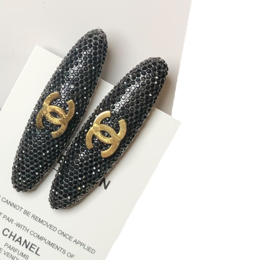 CHANEL 2Pc Black Rhinestone/Gold CC Long Oval L.A Collection Hair Clips: • CHANEL • Gabrielle • 2Pc Set • Hair Clips • Black Rhinestone • Gold CC Logo • Black Tone Hardware • Long Oval Shaped • L.A Collection • Unopened/In
