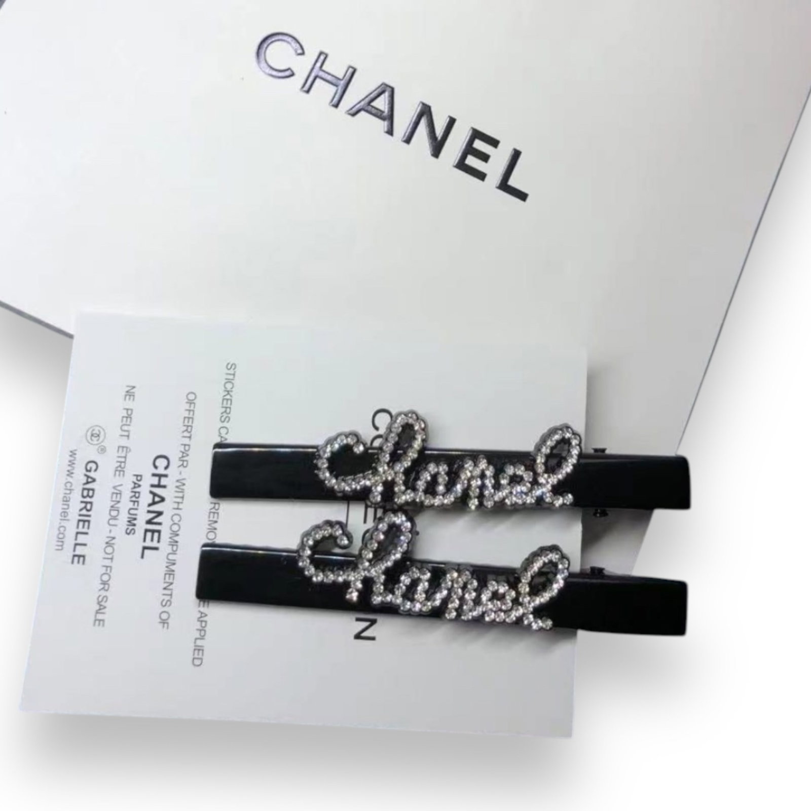 CHANEL 2Pc Black/White Rhinestone CC Logo L.A Collection Hair Clips: • CHANEL • Gabrielle • 2Pc Set• Black• White Rhinestone Covered CHANEL Logo• Black Tone Hardware• L.A Collection• Hair Clips/Hair Pin • Unopened/In Origina