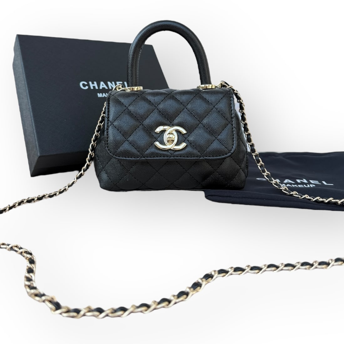 CHANEL Black/Gold Quilted CoCo Top Handle Beaute Bag & Original Box: • CHANEL • Black • Quilted Pattern • Gold Tone Hardware • Signature Front CC Logo Twist Lock Closure • Top Handle For Optional Carry • Intertwined Leather Chain Stra