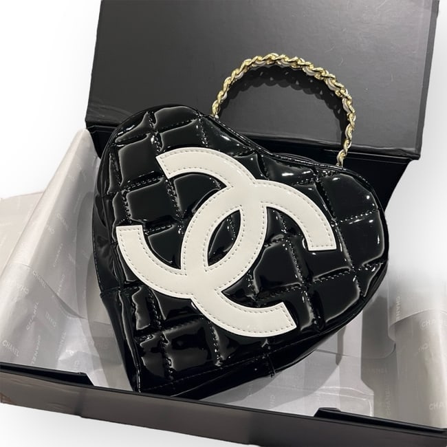 CHANEL Black/White CC Heart Top Handle Beaute Bag & Original Box: • CHANEL • Black • Patent Quilted Pattern • White CC Front Logo • Top Handle Carry • Zip Closure • Decorated Handle • Gold Tone Hardware • 8.6" x 8.3" (in)
