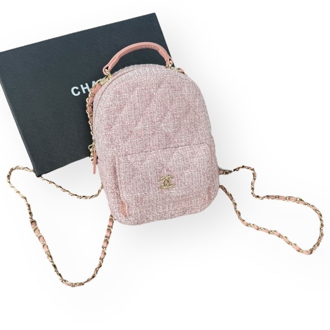CHANEL Pink Tweed 2Way Carry Beaute Mini Backpack & Original Box: • CHANEL • Pink • Tweed Pattern • Front CC Logo • Top Handle Carry • Backpack Carry • Exterior Front Snap Pocket • Zip Closure • 8" x 5.2" (in) • Inte