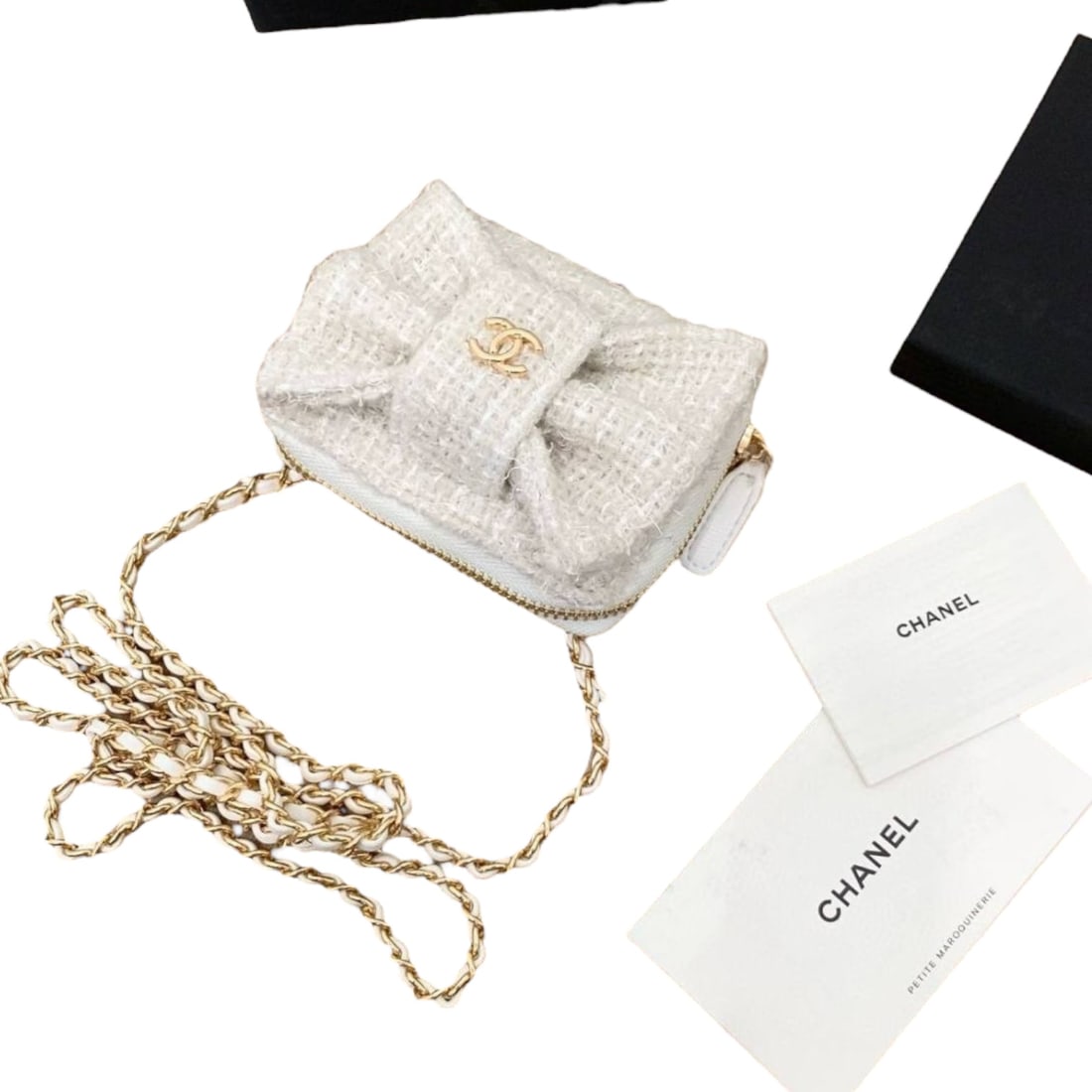 CHANEL White/Gold Bow Detail Beaute Card Holder On Chain & Original Box: • CHANEL • White • Gold Tone Hardware • Card Holder On Chain • Intertwined Leather Chain Strap • Front Bow Detail • Front CC Logo • Zip Closure • 3 Separat